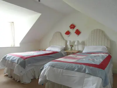 two beds sitting next to each other in a room at Beachcombers in Dumfries