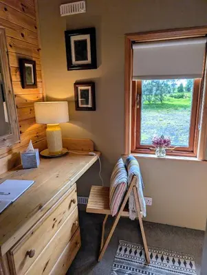 a home office with a desk and a window at Cosy wood cabin in rural area near national park in Cumnock