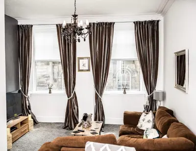 a living room with a couch and two windows at Rose Apartment 2-Bed Apt Sleeps 4 Town Centre Ayr in Ayr