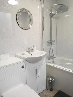 a white bathroom with a sink and a mirror at Adrian House, near Hospital, easy parking + garden in Carlisle