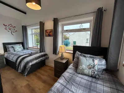 a bedroom with two beds and a window at Solway Firth View in Annan