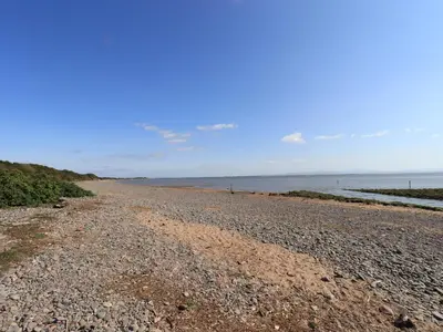 a rocky beach with the ocean in the background at Solway Firth View in Annan