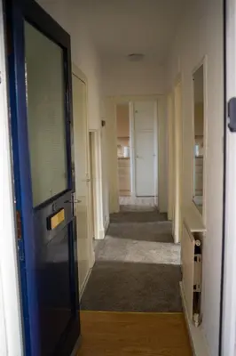 a hallway with a door leading to a room with a hallway at Lovely self-catering apartment in city centre in Dumfries