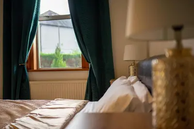 a bedroom with a bed and a window at Lovely self-catering apartment in city centre in Dumfries