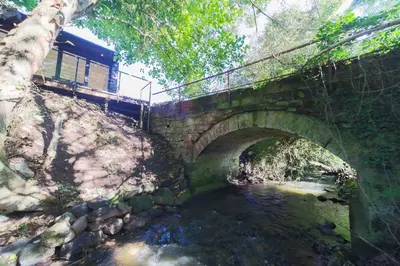 a bridge over a river with a train on it at The Hide in Carlisle