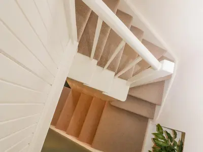 a staircase in a house with white ceilings at Waterside in Ravenglass