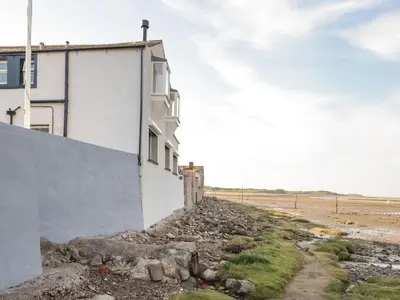 a building on the side of a beach at Waterside in Ravenglass