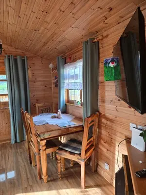 a dining room with a table and chairs in a cabin at Unique Caravan with Outdoor Space Lodge in Ballantrae
