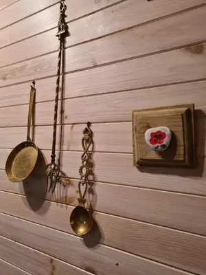 a wall with two spoons and a plate and a spoon at Unique Caravan with Outdoor Space Lodge in Ballantrae