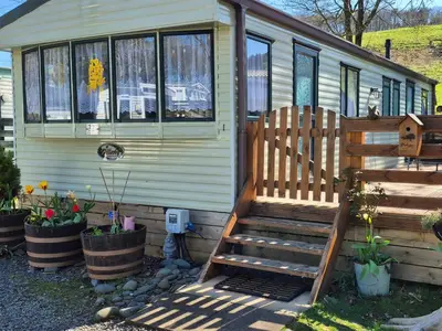 a stairs leading up to a tiny house at Westmorland 32 caravan in Ballantrae