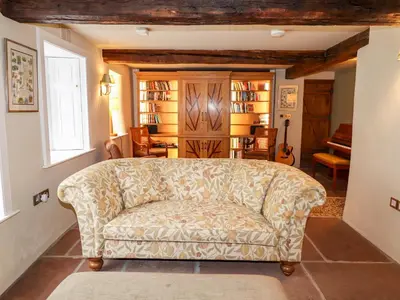 a living room with a couch in a room at Eagle Farmhouse in Glenridding