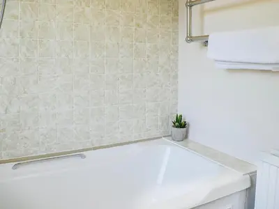 a bathroom with a white sink and a toilet at Woodend Farmhouse Halmyre in Haugh of Urr