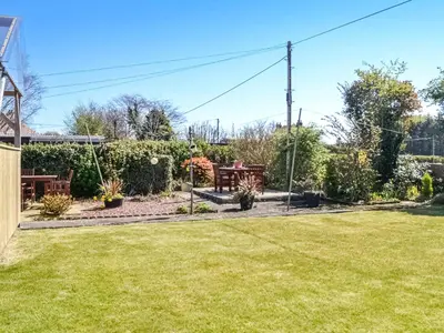 a garden with a picnic table and a lawn at Kinvara in Stranraer