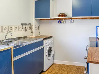 a kitchen with a sink and a washing machine at Ardencaple No 2 in Castle Douglas