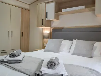 a bedroom with a bed with towels on it at Graylings Rest - Uk35759 in Brigham
