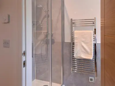 a shower stall in a bathroom with a towel at Inverallan in Amisfield Town