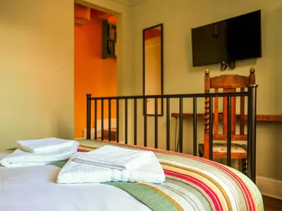 a bedroom with a bed with towels on it at Holst Apartment in Newton Stewart