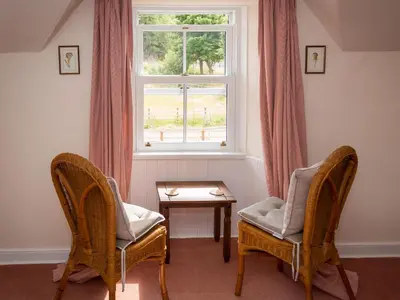 two chairs and a table in front of a window at Uk35715 - South Cottage in Teviothead