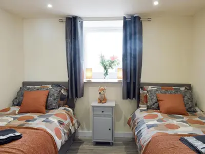 a bedroom with two beds and a window at Uk7385 - Chaff House in Newmilns
