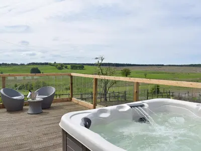a bath tub on a deck with a view of a field at Uk7385 - Chaff House in Newmilns