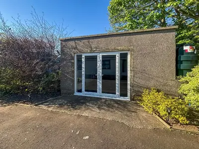 a garage with a white door on a building at Rowan Muir in Springside