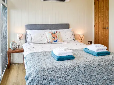 a bedroom with a bed with two pillows on it at The Seaview Snug in Whithorn