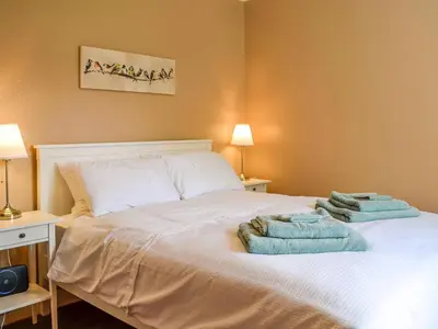 a bedroom with a bed with towels on it at Sunnyside in New Galloway