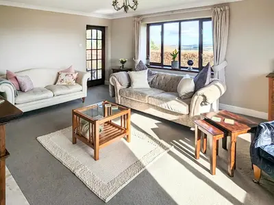 a living room with two couches and a table at High Mains in Winscales