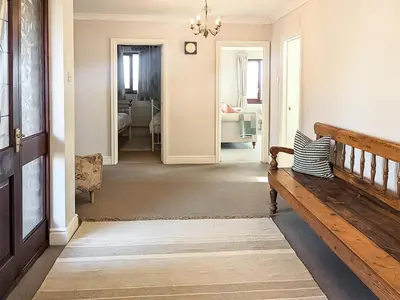 a hallway with a bench and a living room at High Mains in Winscales
