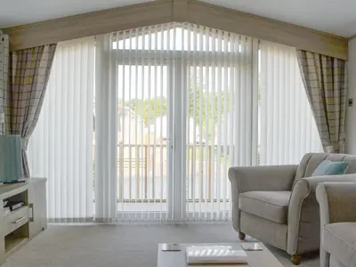 a living room with a couch and a large window at Tranquil Lodge - Uk35277 in Brigham