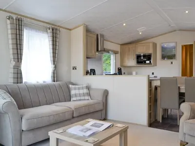 a living room and kitchen with a couch and a table at Tranquil Lodge - Uk35277 in Brigham