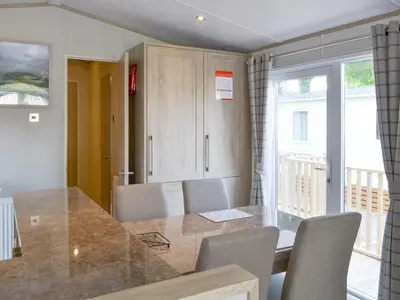 a kitchen with a table and chairs and a window at Tranquil Lodge - Uk35277 in Brigham