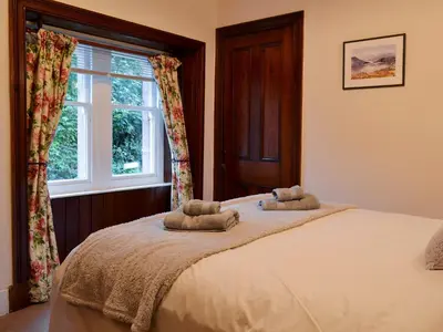 a bedroom with a bed with two towels on it at Lealholme in Bassenthwaite