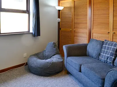 a living room with a couch and a chair at Westlin in Penpont