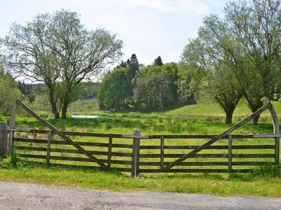 a wooden gate in a field with a fence at Uk35716 - North Cottage in Teviothead