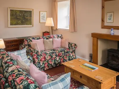 a living room with a couch and a table at Uk35716 - North Cottage in Teviothead