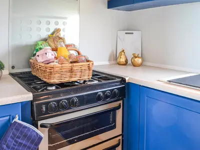 a kitchen with a stove with a basket on it at The Seaview Retreat - Uk35883 in Broughton Mains