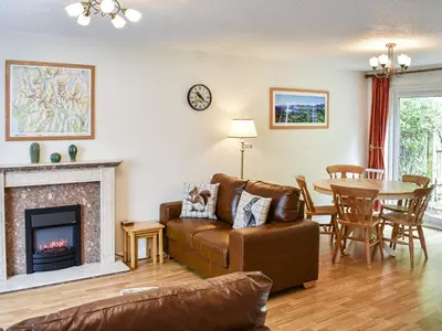 a living room with a couch and a fireplace at Jane Eyre Cottage in Keswick
