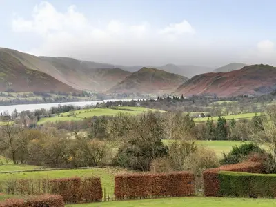a view of a valley with mountains in the background at Mell Fell in Watermillock