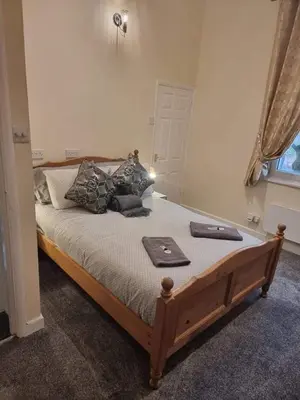a bedroom with a bed with a tray on it at Carlisle City Centre, Cute Victorian House. in Carlisle