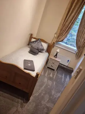 a small bed in a small room with a window at Carlisle City Centre, Cute Victorian House. in Carlisle