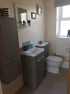 a bathroom with a toilet and a sink at West View Cottage in Seaside Village of Allonby Cumbria in Allonby