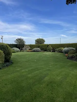 a large yard with green grass and bushes at Galloway Farmstay Claunch in Newton Stewart