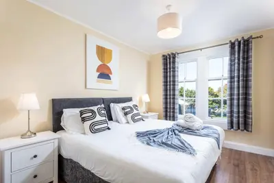 a bedroom with a bed and a window at The Orchard - Donnini Apartments in Ayr