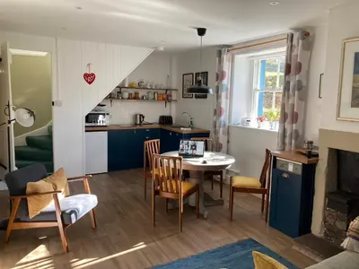 a kitchen and living room with a table and chairs at Penny End, Mosser - Western Lakes and great walks in Cockermouth