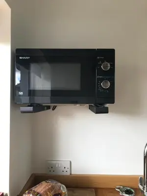a microwave oven hanging on a wall at The Nook at Claremont House CA12 4LT in Keswick