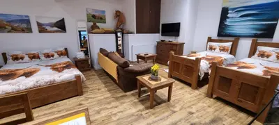 a room with two beds and a tv in it at Scafell Cottage on The Big 