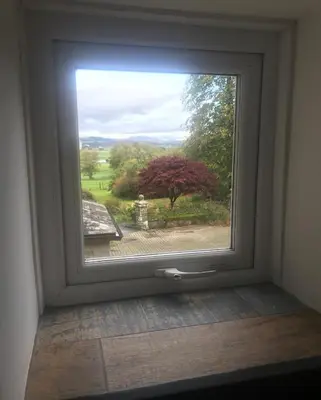 a window with a view of a garden outside at 1-Bed studio Apartment nr Cockermouth in Cockermouth
