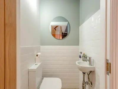 a bathroom with a white toilet and a sink at The Barn Owl - Uk36217 in Bowness-on-Solway
