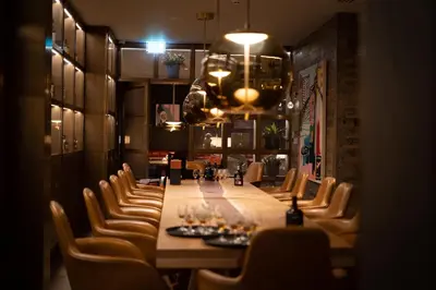 a long dining room with a long table and chairs at Dundonald Links in Dreghorn